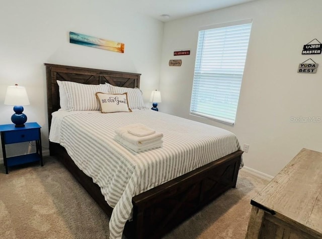 carpeted bedroom with baseboards
