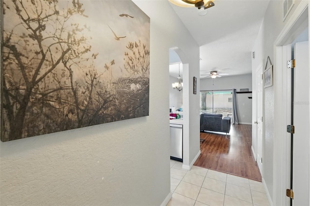 203 La Mirage St, Davenport, FL 33897 - hallway featuring tile patterned floors, baseboards, and arched walkways