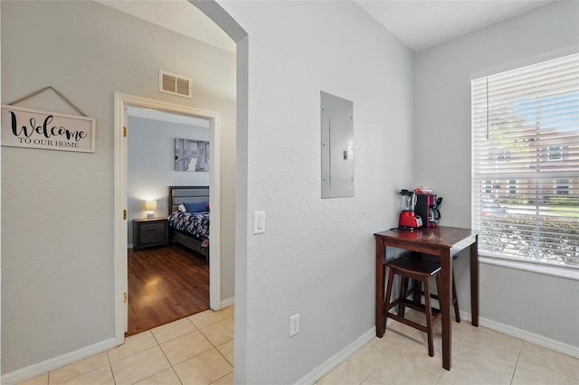 203 La Mirage St, Davenport, FL 33897 - corridor featuring electric panel, arched walkways, baseboards, and light tile patterned flooring