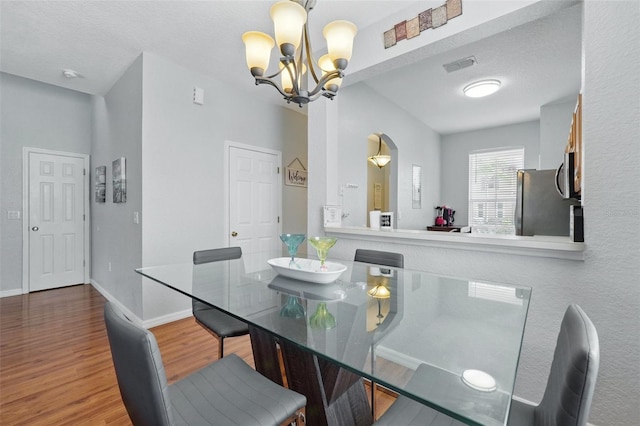 203 La Mirage St, Davenport, FL 33897 - dining room featuring a chandelier, wood finished floors, and baseboards
