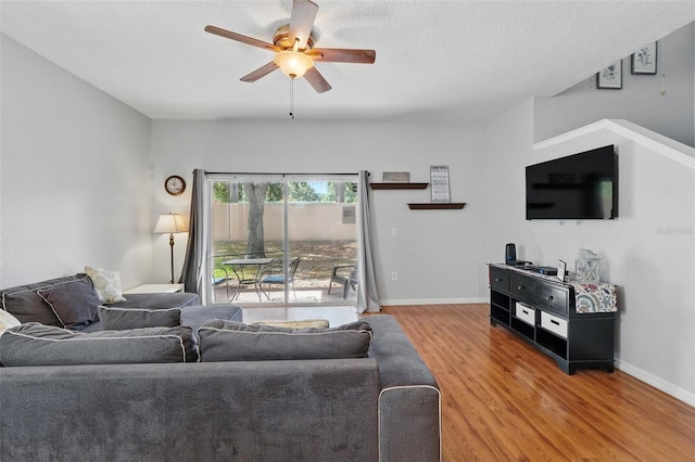 203 La Mirage St, Davenport, FL 33897 - living room featuring ceiling fan, light wood finished floors, and baseboards