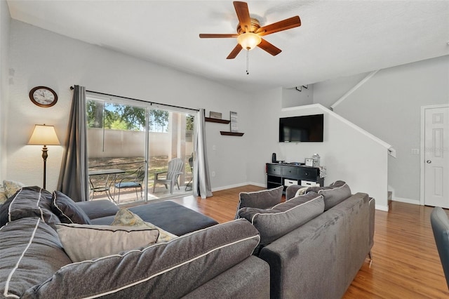203 La Mirage St, Davenport, FL 33897 - living room with light wood-style floors, a ceiling fan, baseboards, and stairway