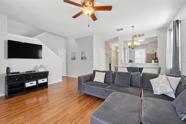 203 La Mirage St, Davenport, FL 33897 - living area featuring light wood-style floors, a chandelier, ceiling fan, and baseboards