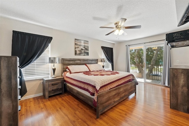 203 La Mirage St, Davenport, FL 33897 - bedroom with access to exterior, light wood-style flooring, a textured ceiling, ceiling fan, and baseboards