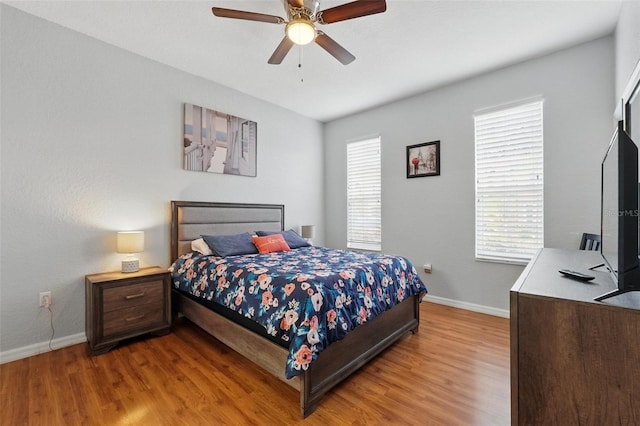 203 La Mirage St, Davenport, FL 33897 - bedroom with baseboards, light wood-type flooring, and a ceiling fan