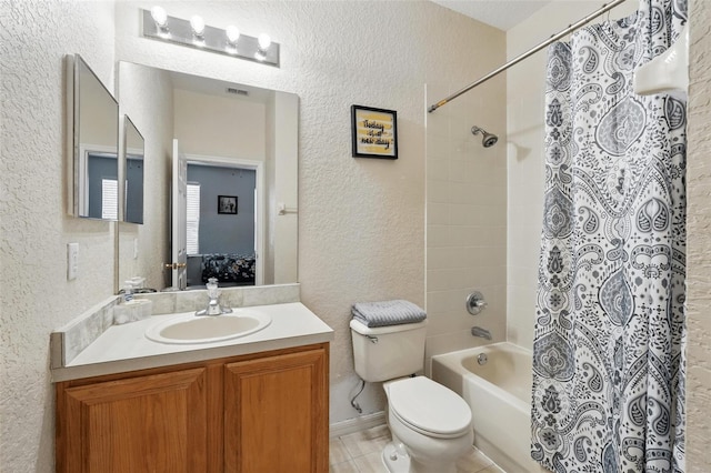 203 La Mirage St, Davenport, FL 33897 - full bathroom featuring a textured wall, toilet, shower / tub combo, vanity, and tile patterned floors
