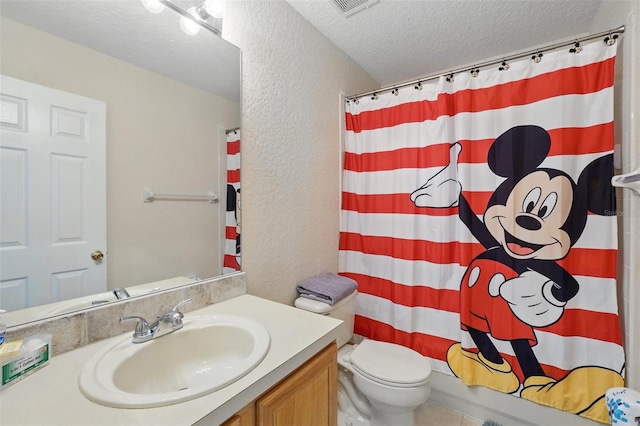 203 La Mirage St, Davenport, FL 33897 - bathroom with a textured wall, a textured ceiling, vanity, and toilet