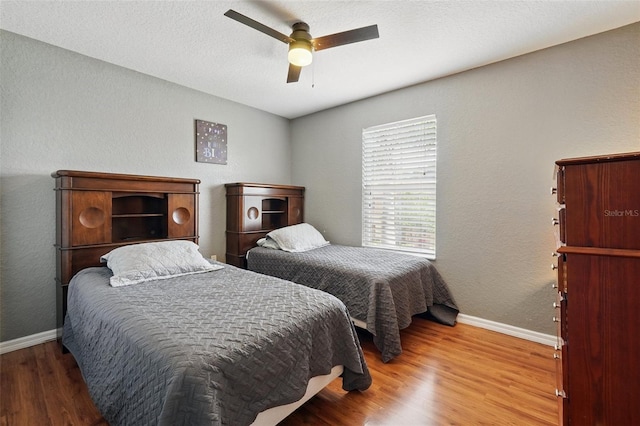203 La Mirage St, Davenport, FL 33897 - bedroom with baseboards, wood finished floors, and a ceiling fan