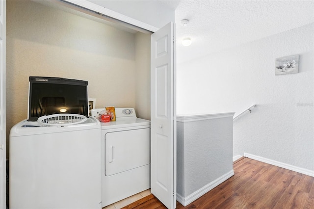 203 La Mirage St, Davenport, FL 33897 - washroom featuring separate washer and dryer, wood finished floors, and baseboards
