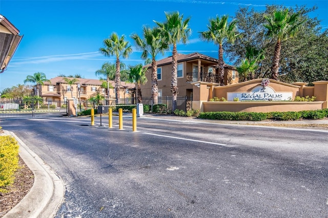 203 La Mirage St, Davenport, FL 33897 - view of asphalt road featuring curbs, a residential view, a gated entry, and a gate