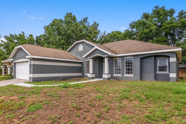 ranch-style home with stucco siding, a front lawn, and an attached garage