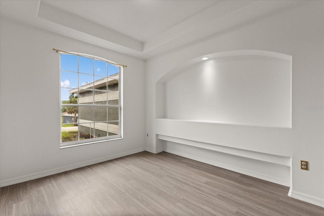 empty room featuring wood finished floors and baseboards