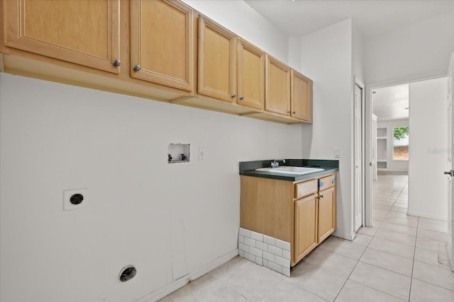 laundry area with washer hookup, electric dryer hookup, light tile patterned floors, and cabinet space
