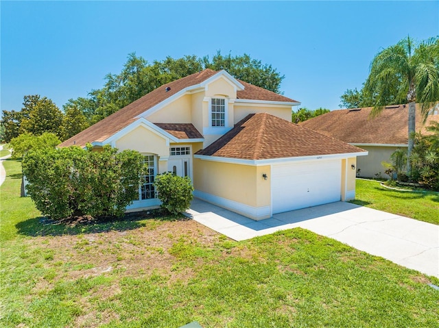 3203 Herons Point Cir, Kissimmee, FL 34741 - view of front of house featuring an attached garage, driveway, a front lawn, roof with shingles, and stucco siding