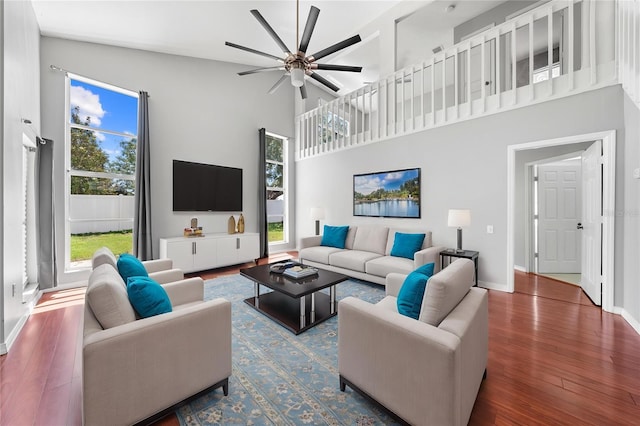 3203 Herons Point Cir, Kissimmee, FL 34741 - living room featuring a ceiling fan, wood finished floors, high vaulted ceiling, and baseboards