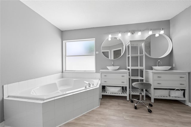 3203 Herons Point Cir, Kissimmee, FL 34741 - full bath with a garden tub, wood finished floors, and two vanities