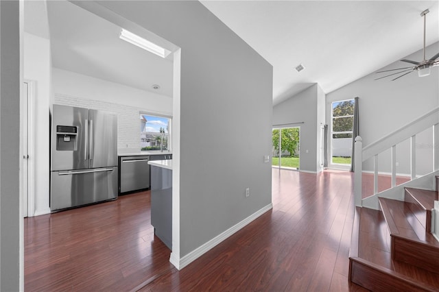 3203 Herons Point Cir, Kissimmee, FL 34741 - hall featuring stairs, dark wood-style flooring, lofted ceiling, and baseboards