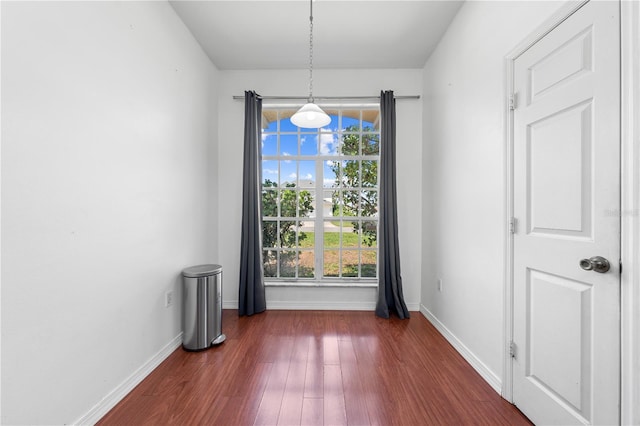 3203 Herons Point Cir, Kissimmee, FL 34741 - unfurnished dining area with dark wood-style floors and baseboards