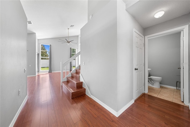3203 Herons Point Cir, Kissimmee, FL 34741 - hallway featuring hardwood / wood-style floors, baseboards, stairs, and lofted ceiling