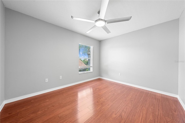 3203 Herons Point Cir, Kissimmee, FL 34741 - unfurnished room with a ceiling fan, wood finished floors, and baseboards