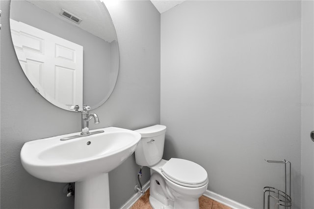 3203 Herons Point Cir, Kissimmee, FL 34741 - half bathroom featuring toilet, tile patterned flooring, and baseboards
