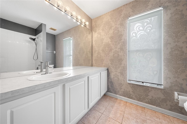 3203 Herons Point Cir, Kissimmee, FL 34741 - bathroom with tile patterned floors, baseboards, vanity, and a shower