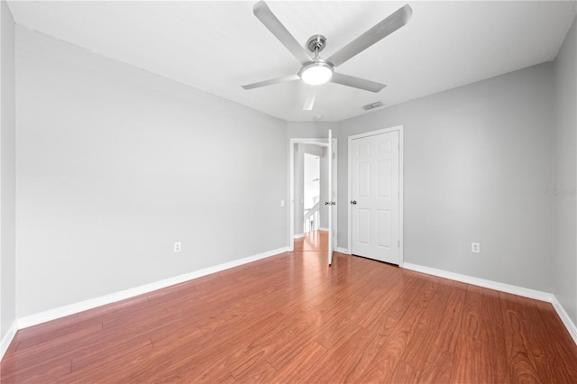 3203 Herons Point Cir, Kissimmee, FL 34741 - unfurnished room featuring baseboards, wood finished floors, and a ceiling fan
