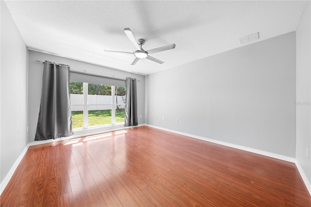 3203 Herons Point Cir, Kissimmee, FL 34741 - spare room with ceiling fan, wood finished floors, baseboards, and a textured ceiling