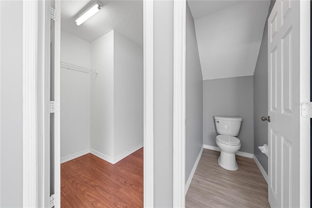 3203 Herons Point Cir, Kissimmee, FL 34741 - bathroom featuring toilet, wood finished floors, and baseboards