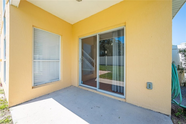 3203 Herons Point Cir, Kissimmee, FL 34741 - property entrance with a patio and stucco siding