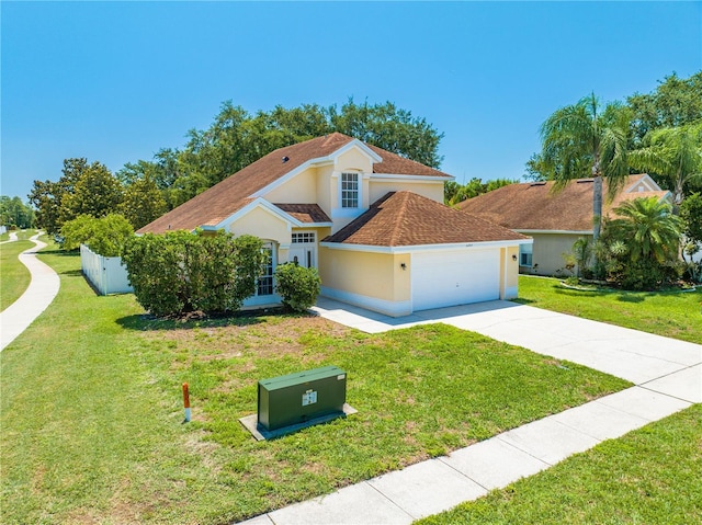 3203 Herons Point Cir, Kissimmee, FL 34741 - view of front of property featuring a garage, concrete driveway, stucco siding, and a front lawn