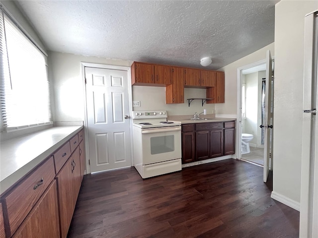 1413 11th St, Saint Cloud, FL 34769 - kitchen featuring white electric range oven, dark wood-style floors, light countertops, a textured ceiling, and brown cabinetry
