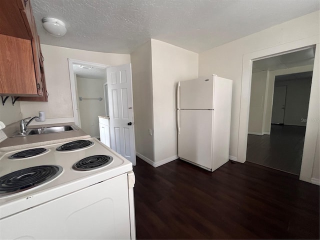 1413 11th St, Saint Cloud, FL 34769 - kitchen with white appliances, a sink, dark wood-style floors, brown cabinets, and light countertops
