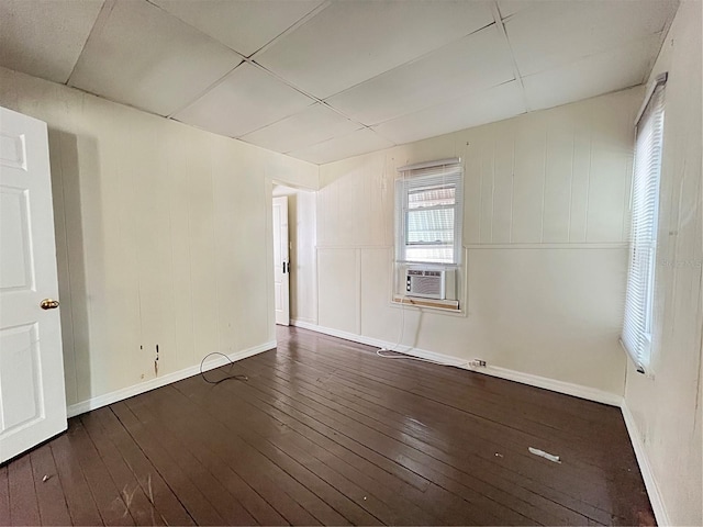 1413 11th St, Saint Cloud, FL 34769 - spare room with wood-type flooring, baseboards, and cooling unit