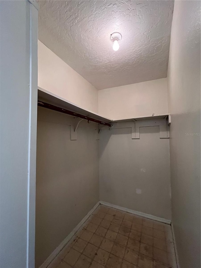 1413 11th St, Saint Cloud, FL 34769 - walk in closet featuring tile patterned floors