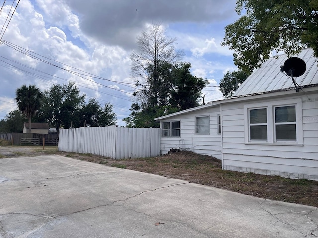 1413 11th St, Saint Cloud, FL 34769 - view of side of property featuring fence and a patio area