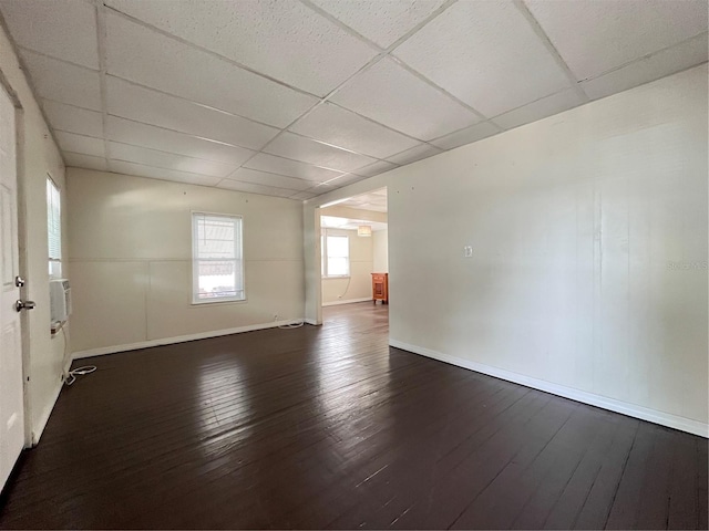 1413 11th St, Saint Cloud, FL 34769 - empty room with a paneled ceiling, dark wood-style flooring, and baseboards