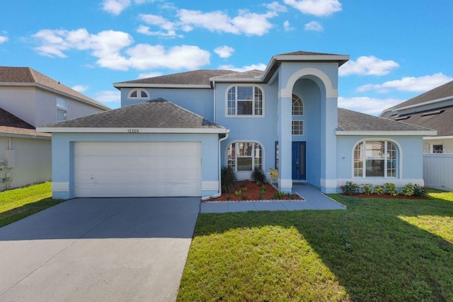 12303 Bohannon Blvd, Orlando, FL 32824 - view of front facade featuring stucco siding, an attached garage, concrete driveway, and a front yard