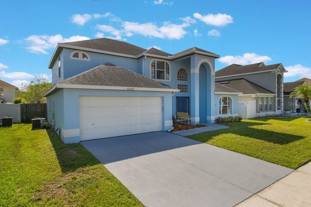 12303 Bohannon Blvd, Orlando, FL 32824 - view of front of house with stucco siding, cooling unit, an attached garage, and driveway