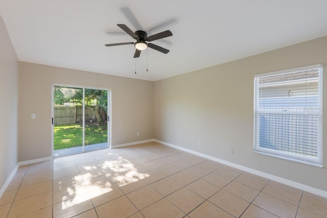 12303 Bohannon Blvd, Orlando, FL 32824 - empty room featuring a ceiling fan, light tile patterned flooring, and baseboards