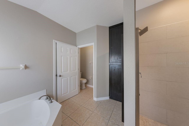 12303 Bohannon Blvd, Orlando, FL 32824 - full bathroom with toilet, tile patterned flooring, a garden tub, tiled shower, and baseboards