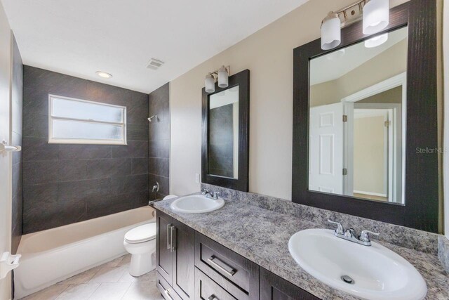 12303 Bohannon Blvd, Orlando, FL 32824 - full bathroom with toilet, bathtub / shower combination, double vanity, and tile patterned flooring