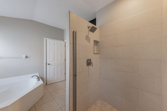 12303 Bohannon Blvd, Orlando, FL 32824 - bathroom with a stall shower, a garden tub, tile patterned floors, and vaulted ceiling