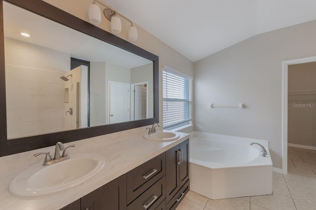 12303 Bohannon Blvd, Orlando, FL 32824 - full bathroom featuring tile patterned flooring, tiled shower, lofted ceiling, a bath, and double vanity