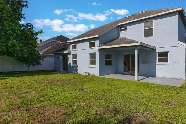 12303 Bohannon Blvd, Orlando, FL 32824 - rear view of property with stucco siding, a patio area, and a shingled roof