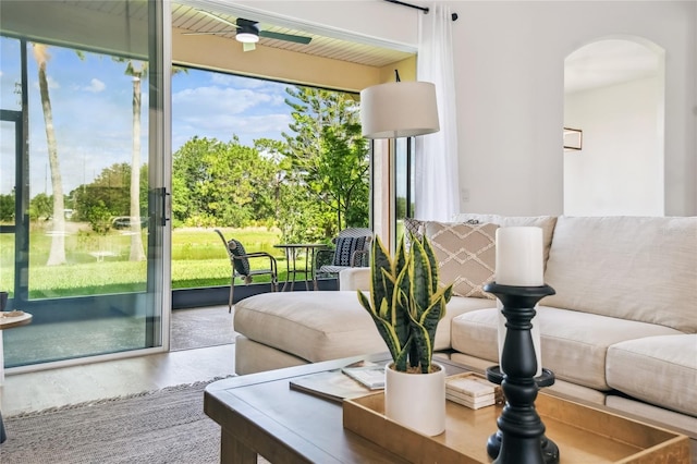 517 Milano Rd, Poinciana, FL 34759 - living area featuring arched walkways, healthy amount of natural light, and wood finished floors