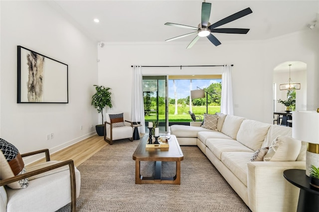 517 Milano Rd, Poinciana, FL 34759 - living room featuring ornamental molding, ceiling fan, light wood finished floors, baseboards, and a chandelier