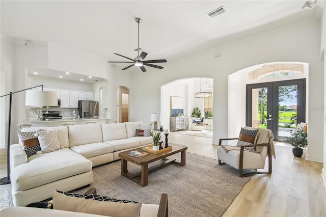 517 Milano Rd, Poinciana, FL 34759 - living area featuring arched walkways, light wood-style flooring, crown molding, a ceiling fan, and recessed lighting