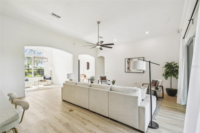 517 Milano Rd, Poinciana, FL 34759 - living area with arched walkways, light wood finished floors, recessed lighting, and a ceiling fan