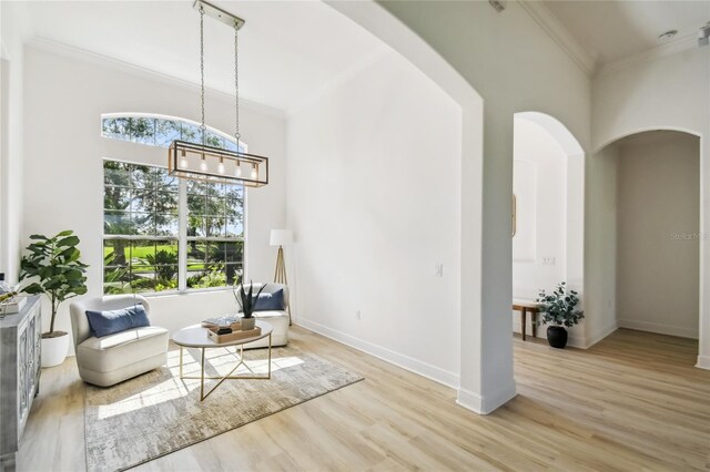 517 Milano Rd, Poinciana, FL 34759 - living area with plenty of natural light, arched walkways, wood finished floors, crown molding, and baseboards